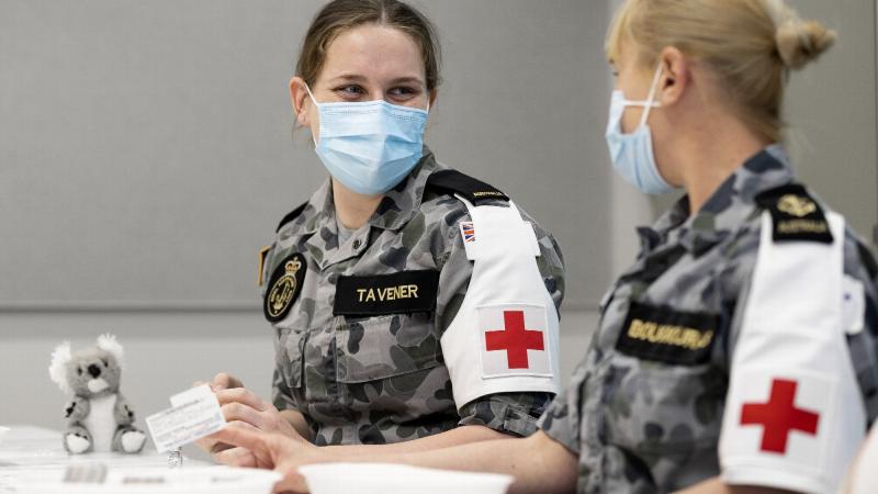 Seaman Alexis Tavener and Leading Seaman Katrina Bougiouras prepare Covid-19 vaccinations at the Orange Vaccination Hub while deployed on NSW Operation COVID-19 Assist. Photo: Corporal Dustin Anderson