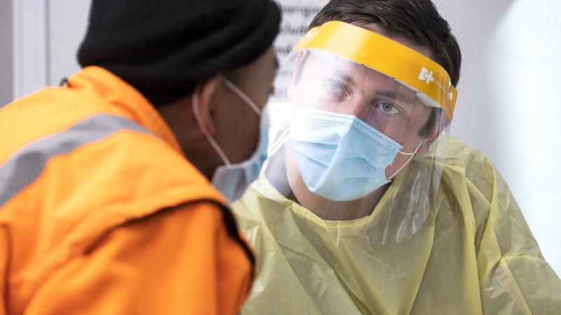 Private John Daley assists a member of the Orange community before receiving their Covid-19 Vaccination at the Orange Vaccination Hub as a part of NSW Operation COVID-19 Assist. Photo: Corporal Dustin Anderson