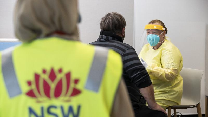 Chief Petty Officer Tina Elliot assists a member of the Orange community before receiving their vaccination at the city's vaccination hub. Photo: Corporal Dustin Anderson