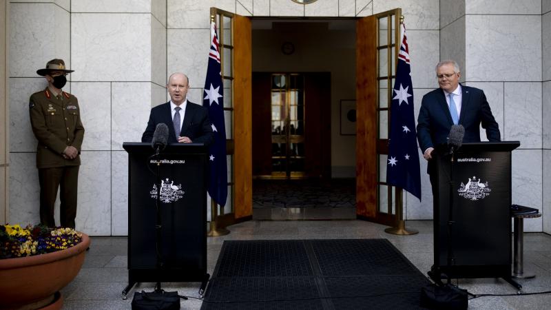 From Left, Chief of the Defence Force General Angus Campbell, Secretary of Defence Greg Moriarty and Prime Minister Scott Morrison announce the AUKUS alliance and nuclear submarine acquisition at Parliament House, Canberra yesterday. Photo: Jay Cronan