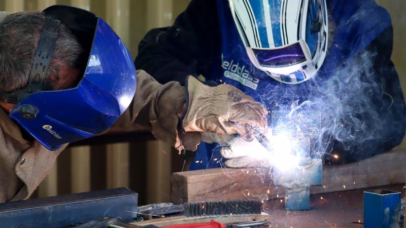 Sapper Malcolm Stewart, left, teaches Andrew Poonkamelya, a local member from the Pormpuraaw Community in Cape York Peninsula, welding techniques during AACAP 2021.