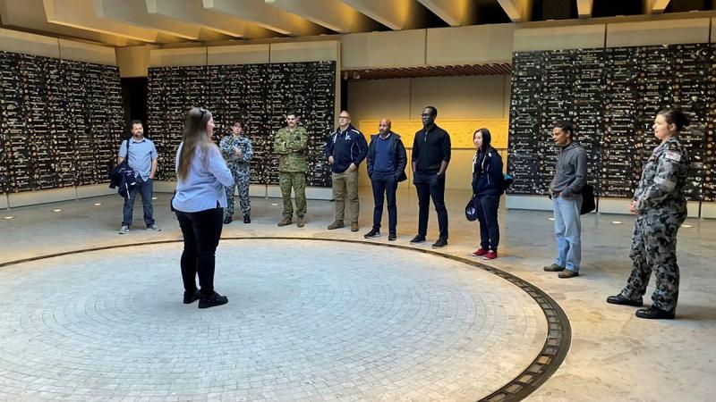Ashleigh Taylor, from the Anzac Memorial, guides ADF Cyber Gap Program participants around the memorial in Sydney's Hyde Park.