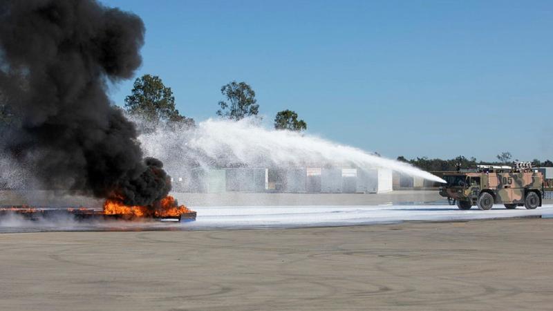 Air Force’s No. 23 Squadron Aviation Rescue and Fire Fighting personnel apply fluorine-free foam to extinguish a large demonstration aviation fuel blaze. Photo: Sergeant Andrew Eddie