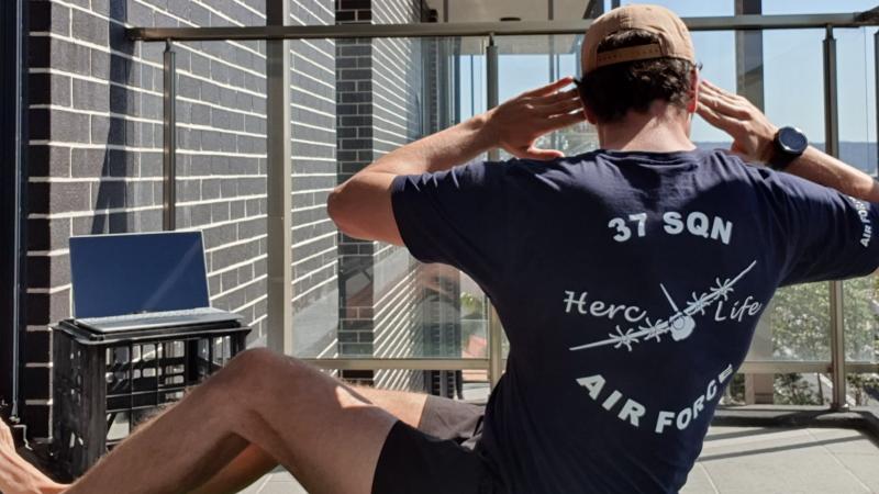 Air Force physical training instructor Corporal Owen Hingston, of No. 22 Squadron, completes an exercise routine from home as part of the online HERCFIT physical and mental wellbeing program with No. 37 Squadron.