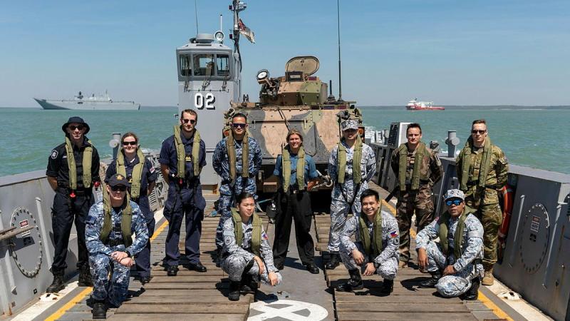 Foreign personnel embarked in Navy ships for Indo-Pacific Endeavour 21 in a landing craft from HMAS Canberra off the Port of Darwin before departing for the exercise. Photo: Leading Seaman Sittichai Sakonpoonpol