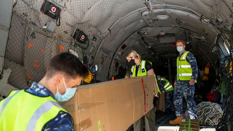 Air movements operators from No. 23 Squadron and loadmasters from No. 35 Squadron load engineering equipment bound for Fiji onto an Air Force C-27J Spartan at RAAF Base Amberley. Photo: Leading Aircraftwoman Emma Schwenke