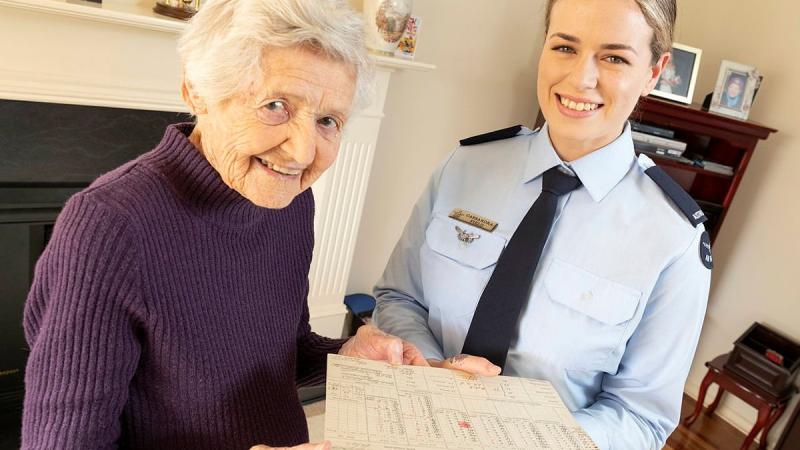 Shirley Stone shows Aircraftwoman Cassandra Field her World War II training certificate during the presentation in Adelaide. Photo: Leading Aircraftman Stewart Gould