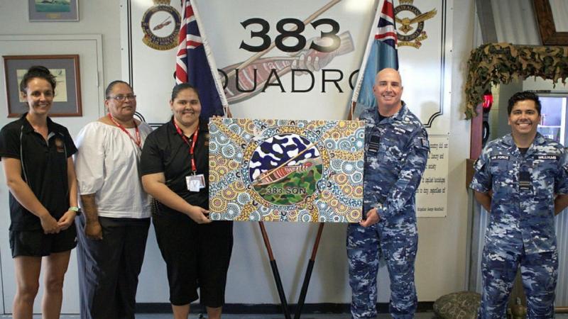 Commanding Officer No. 383 Squadron Wing Commander Alan Brown, centre right, and RAAF Base Townsville Indigenous liaison officer Flight Lieutenant David Williams with artist Kailin Kyle, centre, Stars Foundation's Emma Ferguson, left, and Jean Murphy.