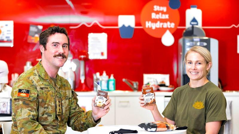 Captain Hugh Johnston and Captain Ashlea Tighe enjoy a post-donation treat at the Sydney Town Hall Lifeblood Donation Centre. Photo: Corporal Dustin Anderson