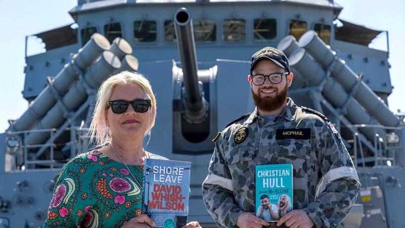 Owner of My Little Bookshop Kerry Ridley with Leading Seaman James McPhail on board HMAS Warramunga at Fleet Base West. Photo: Petty Officer Yuri Ramsey