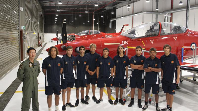 Qualified flying instructor with No. 2 Flying Training School Flight Lieutenant Jonathan Lee and students from Clontarf Academy in front of a Pilatus PC-21 aircraft at RAAF Base Pearce.