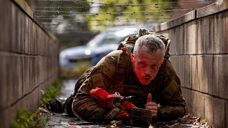 A soldier from the 7th Combat Brigade crawls under barbed wire during the 7th Combat Brigade Commander's Cup obstacle course competition at Gallipoli Barracks, Brisbane. Photo: Corporal Nicole Dorrett