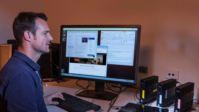 Defence scientist Mark Beaumont using the Cross Domain Desktop Compositor to securely access and combine information spread across multiple computer networks.