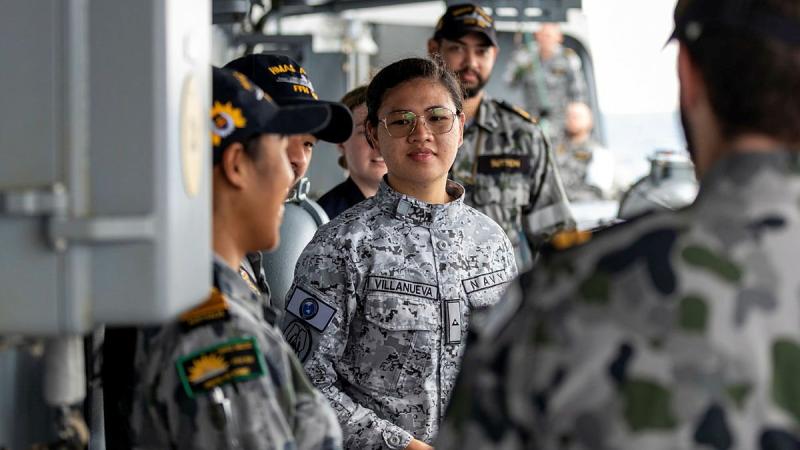 A Philippine Navy officer is greeted on board HMAS Anzac during a cross-deck exchange as part of Indo-Pacific Endeavour 21. Photo: Leading Seaman Leo Baumgartner