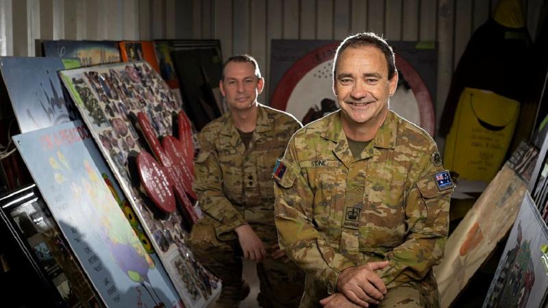 Lieutenant Colonel Andrew White, left, and Warrant Officer Class Two Daryl Stone at Australia's main operating base in the Middle East with ADF historic artefacts. Photo: Sergeant Glen McCarthy