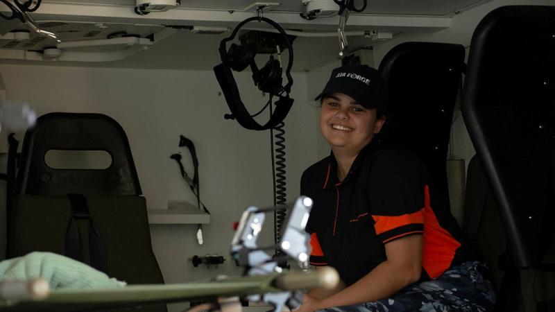 Indigenous Youth Program student Andrea Cole in a No. 1 Expeditionary Health Squadron Bushmaster ambulance during a visit to RAAF Base Townsville. Photo: Leading Aircraftwoman Annalin Wright