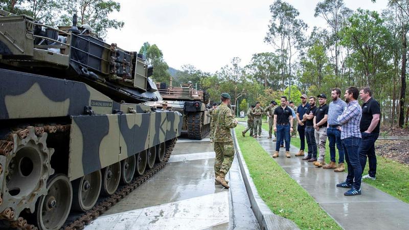 A group of civilians who bid for an Army experience in a charity auction supporting Legacy are given details about the M1A1 Abrams main battle tank at Gallipoli Barracks. Photo: Corporal Kerry Uilderks