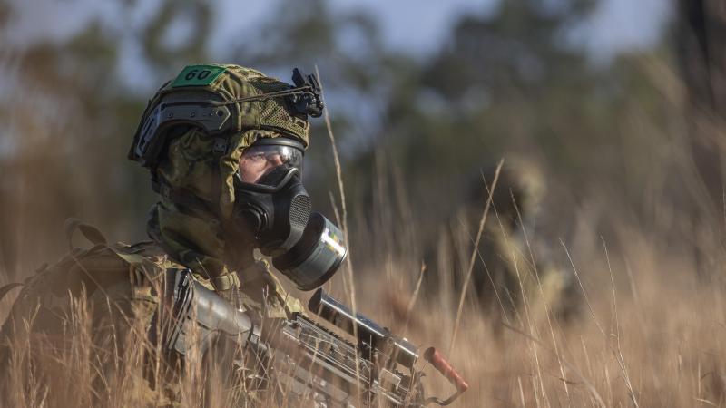 A soldier from the 6th Battalion, Royal Australian Regiment, wears the new protective mask while patrolling during a simulated chemical, biological, radiological and nuclear survival training exercise at Townsville. Photo: Corporal Nicole Dorrett