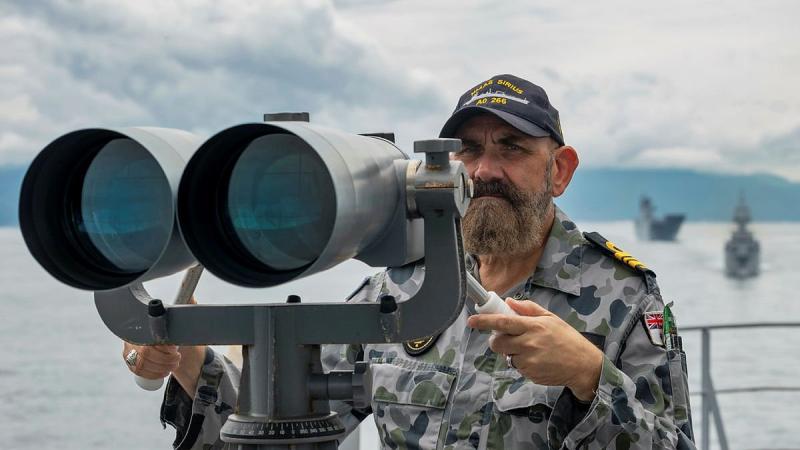 Lieutenant Commander Richard Mingramm looks out from the starboard bridge wing of HMAS Sirius, as the ship departs Cam Rah Bay, Vietnam, during Indo-Pacific Endeavour 2021. Photo: Leading Seaman Sittichai Sakonpoonpol