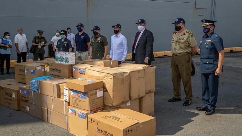 Personnel from HMAS Canberra deliver personal protective equipment to Manila, Philippines, during Indo-Pacific Endeavour 2021. Photo: Petty Officer Christopher Szumlanski