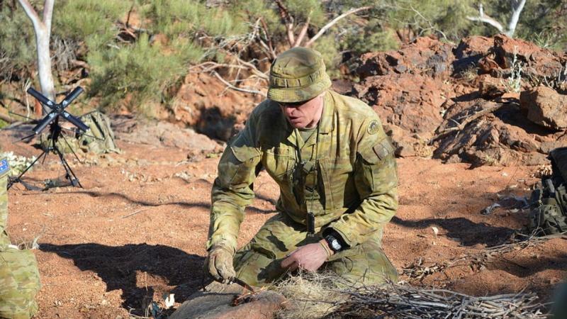 Corporal Andrew Ball demonstrates lighting a fire with a fero rod on Exercise Emu Walk.