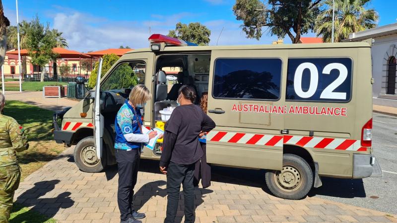 Pika Wiya registered nurse Rebecca Simpson conducts a pre-assessment in the Port Augusta town centre before a local receives their COVID-19 vaccination out of the ADF ambulance.