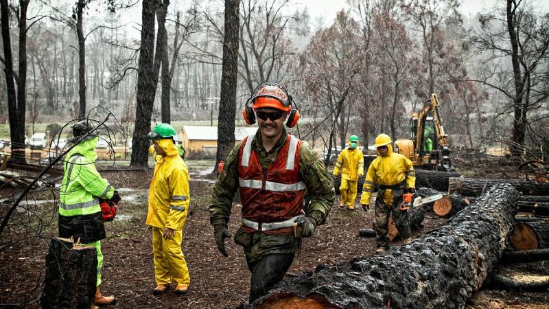 Sapper Zakary Lamrock, of the 5th Combat Engineer Regiment, and Indonesian National Armed Forces troops clear at the Zig Zag Railway, Lithgow, during Operation Bushfire Assist in February last year. Photo: Flight Sergeant Ricky Fuller
