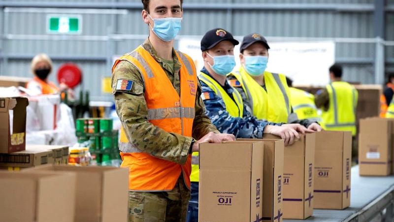 Army Lieutenant Hugh Manson, Aircraftsman Zac Fraser and Able Seaman Renee Shultz assist Foodbank volunteers in preparing food hampers for communities affected by COVID-19, as a part of Operation COVID-19 Assist. Photo credit: Corporal Dustin Anderson