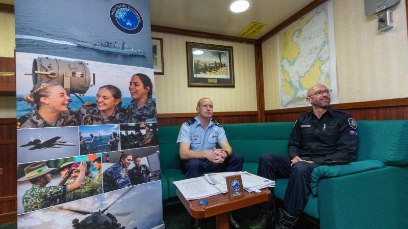 Squadron Leader Chris Hill and Andrew Browne, of the Australian Fisheries Management Authority, attend a virtual workshop on maritime security during a visit to Vietnam. Photo: Leading Seaman Nadav Harel