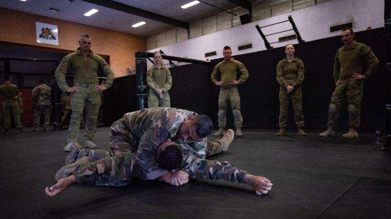 Lieutenant Esafe Vunipola demonstrates a hold on Staff Sergeant Vuna Puloka from His Majesty's Armed Forces Tonga. Photo: Private Jacob Hilton