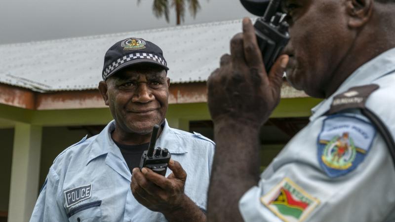 Vanuatu Police Force Inspector Paul Thompson (right) and Sergeant Willie Daniel Obed test their handheld radios at the Tongoa Island Police Post during the Vanuatu Government National Emergency Radio Network project. Photo: Corporal Kieren Whiteley