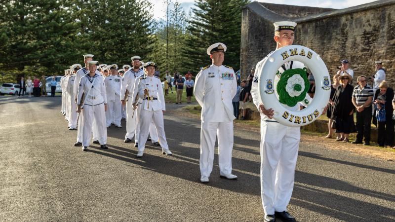 The ship's company of HMAS Sirius stands ready to step off for a march through the streets of Norfolk Island as part of a final visit to the ship's ceremonial home port. Photo: Leading Seaman Sittichai Sakonpoonpol