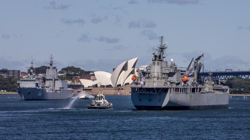 HMAS Sirius, right, sails past her successor, HMAS Supply, during her last entry to Sydney Harbour. Photo: Chief Petty Officer Cameron Martin