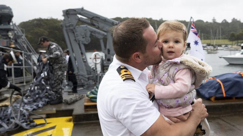 Commanding Officer HMAS Gascoyne, Lieutenant Commander Geoff Crane kisses is daughter on the wharf at HMAS Waterhen following his return home after the completion of a successful deployment. Photo: Petty Officer Tom Gibson