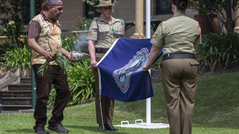 Army soldiers from 1st Psychology Unit watch as Mr Dean Kelly performs a smoking ceremony around the unit flag at Victoria Barracks in Sydney. Photo: Private Jack Brook