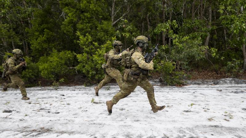 Australian Army soldiers from the 1st Battalion, Royal Australian Regiment, run to the next objective during a clearance patrol through Cowley Beach Training Area. Photo: Corporal Brodie Cross