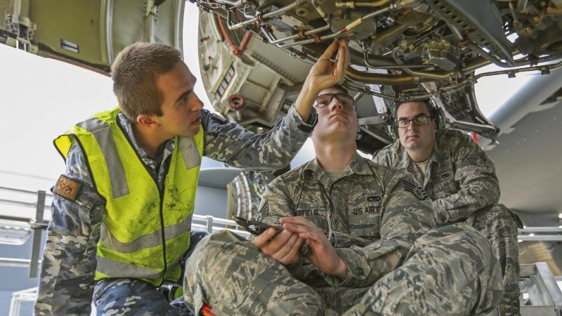 Leading Aircraftman Aaron Kouyoumtzoglou and Staff Sergeant Dustin Sheffield lock wire a fuel filter during the Enhanced Air Cooperation third phase as part of Exercise Pacific Agility. Photo: Corporal Brenton Kwaterski