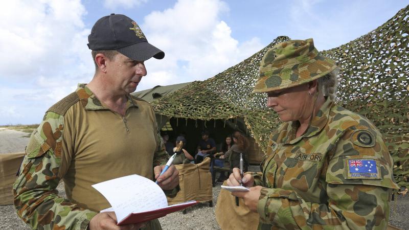 Royal Australian Air Force gender adviser Flight Sergeant Dean Maher provides guidance and advice to Sergeant Rebecca Hass on gender in military operations, as part of Exercise Cope North 19, Baker Airfield, Tinian Island. Photo: Sergeant Kirk Peacock