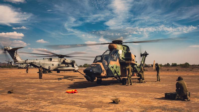 Australian Army Ground Crew Aircraft Support personnel, of the 1st Aviation Regiment, re-arm ARH Tigers at a US Marine Corps CH-53E Super Stallion air deployed ground refuel point, during Exercise Griffin Eagle. Photo: Captain Gavin Partridge