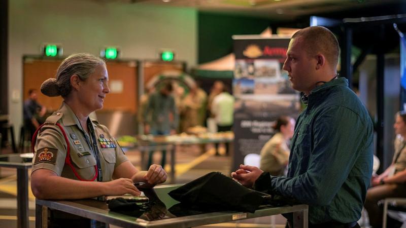 Warrant Officer Class Two Charlotte Hansen, left, of the 20th Regiment, Royal Australian Artillery, talks to Private Zach Holmes, of the 9th Battalion, Royal Queensland Regiment, at the jobs expo in Brisbane. Photo: Private Jacob Hilton