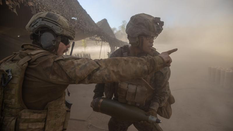 Australian Army Bombardier Damian Williams, left, confirms the ammunition type with United States Marine Corps Lance Corporal Kevin Matias during a live-fire activity as part of Exercise Koolendong. Photo: Corporal Rodrigo Villablanca