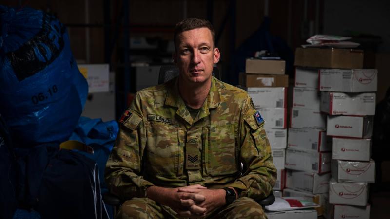 Australian Army Sergeant Alexander Landel in the Joint Task Force 633 post office, while deployed to Operation Accordion in the Middle East region. Photo: Sergeant Glen McCarthy