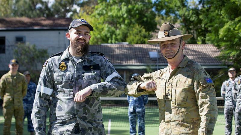Able Seaman Matthew Mu, left, is greeted by National COVID-19 Task Force Commander Brigadier Mick Garraway after being released from quarantine following his attempt to resuscitate a COVID-positive man in Wellington, NSW. Photo: Corporal Kylie Gibson