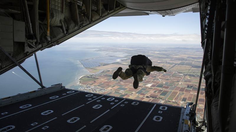 An Australian Army special operations forces soldier conducts a military free-fall parachute jump from a Royal Australian Air Force C-130J Hercules aircraft near RAAF Base Williams. Photo: Sergeant Jake Sims