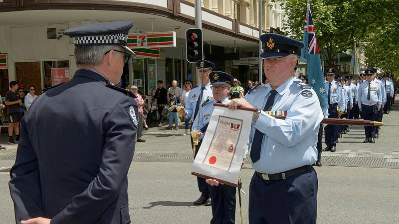 No. 25 (City of Perth) Squadron's Warrant Officer John Markham presents Western Australia Police Assistant Commissioner Allan Adams with the Freedom of Entry scroll during the squadron's Freedom of Entry parade. Photo: Sergeant Gary Dixon