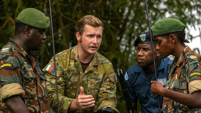 Lance Corporal Ryan Davies speaks with Vanuatu Police Force members Corporal Alex Sope, left, Constable Simeon Samuel and Private Georgette Kalorib  during training with the Barrett 4090 High Frequency Man-Pack Radio. Photo: Corporal Kieren Whiteley