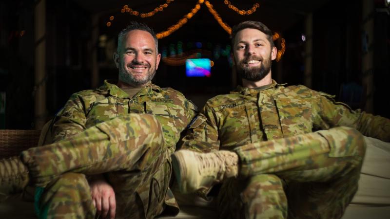Petty Officer Mark Butler (left) and Signaller James Devlin work together to produce a weekly podcast while deployed in the Middle East region. Signaller Devlin has sent a Christmas message to his family back home. Photo: Seargent Glen McCarthy