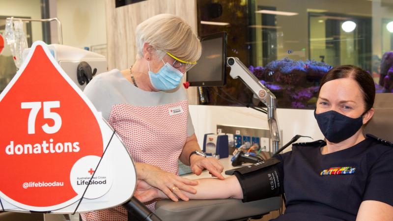 Lifeblood session leader Deb Mackney prepares Wing Commander Haidee Harrison for her 75th donation at the Canberra Red Cross Lifeblood Donation Centre. Photo: Sergeant Rob Hack
