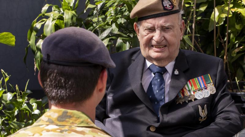 Australian Army soldier Corporal A, from the 1st Commando Regiment, talks with Second World War British Army veteran Mr John Morris in the garden of his home in Merrylands, Sydney. Photo: Chief Petty Officer Cameron Martin