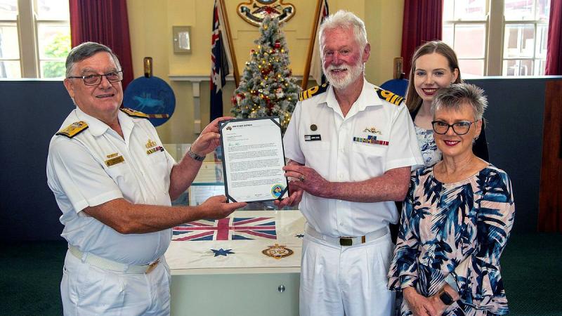 Commodore Greg Yorke Senior Naval Officer Victoria, presents a farewell letter on behalf of Chief of Navy to Commander John Goss, in company with his wife, Commander Janine March-Goss, and their daughter Ebony at HMAS Creswell. Photo POIS James Whittle